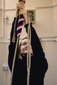Person holding rope and ringing bell