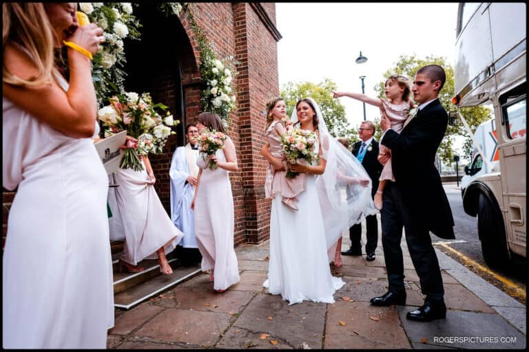 Saffie and Zac with bridesmaids and flower girls outside the church